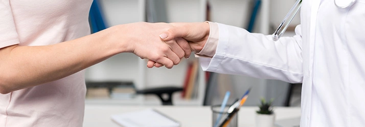 Healthcare professional and patient shaking hands